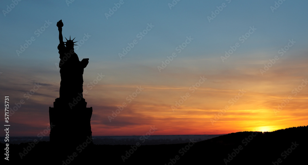 Silhouettes of The Statue of Liberty at sunset. Greeting card for Independence Day. USA celebration.