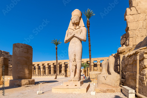 The monumental statue of King Ramesses II with Princess Bent'anta at his feet inside the Temple of Karnak, Luxor Egypt.	