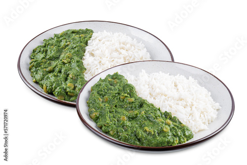Spinach dahl with rice in a plate on a white isolated background