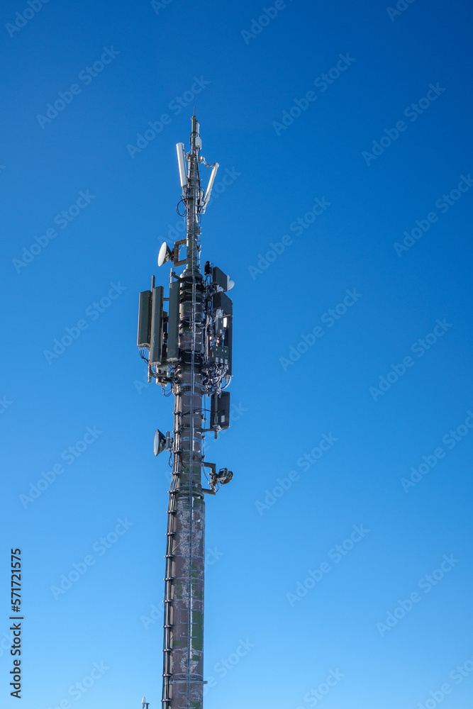 a radio mast with many antennas stands in the alps a radio mast with many antennas stands in the alps