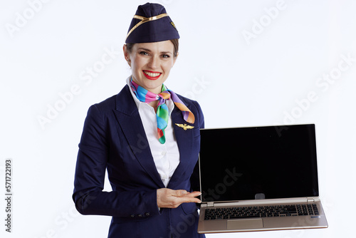 happy flight attendant woman on showing laptop blank screen