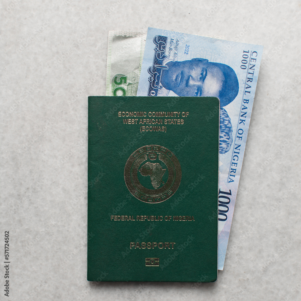 Fototapeta premium The new Nigerian 1000 and 500 Naira notes in a nigerian passport, Nigeria's new currency in a passport