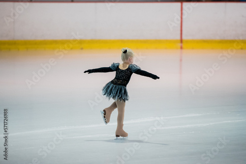 Figure skating of a little 4 year old girl. First competition. Excitement, pride.