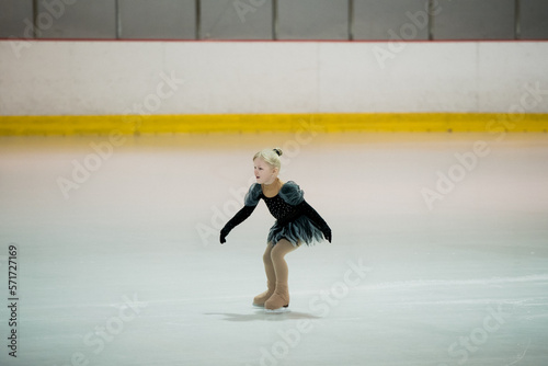 Figure skating of a little 4 year old girl. First competition. Excitement, pride.