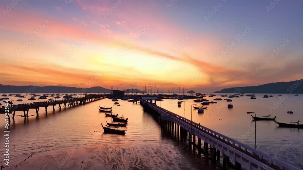 .aerial view scenery sunrise above Chalong pier..4K vdo of Majestic sunrise landscape Amazing light of nature cloudscape sky above mountain range. .boats yacht in Chalong marina gulf background. .aerial view scenery sunrise above Chalong pier..4K vdo of Majestic sunrise landscape Amazing light of nature cloudscape sky above mountain range. .boats yacht in Chalong marina gulf background.