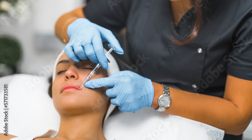 Woman getting a face modelling injection in aesthetic mediine clinic. High quality photo