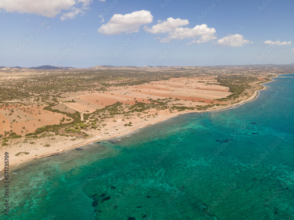 Beautiful azure sea and sandy shore. Wild nature. Warm summer photo. Top view, drone filming.