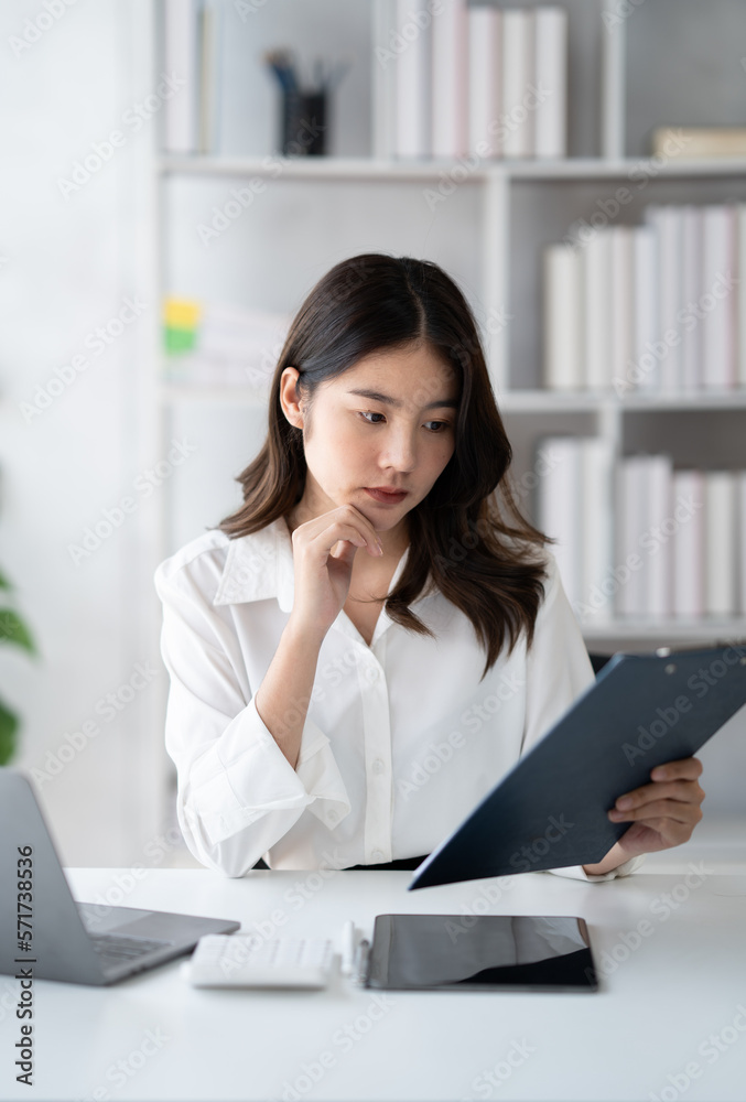 Portrait of young beautiful businesswoman working on her project in the office room, preparing for the next meeting in th company. Portrait of young beautiful businesswoman working on her project in the office room, preparing for the next meeting in th company.
