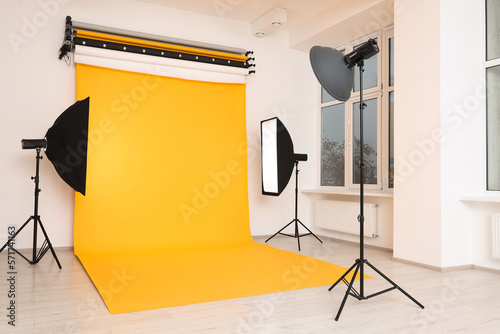 Interior of modern photo studio with professional lighting equipment