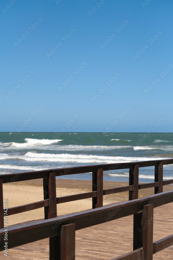 Combination between pier and sea, contemplating the horizon, vertical photo