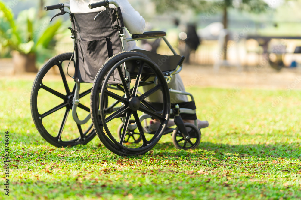 Fototapeta premium Happy asian elderly woman sitting on wheelchair outdoor in park relax your mind with green nature.
