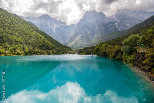 Green, turquoise lake water in Blue Moon Valley, Yunnan, China in the summer. Stunning mountain landscape, copy space for text
