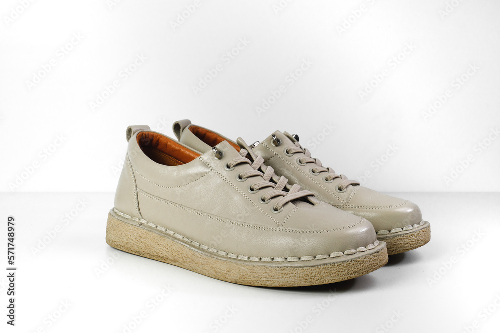 Beige Trendy Sneakers. Fashion shoes still life. Stylish photo boots in the studio.  casual shoes, fashion, footwear, shoe concept, retro, back to school. 