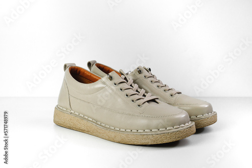 Beige Trendy Sneakers. Fashion shoes still life. Stylish photo boots in the studio. casual shoes, fashion, footwear, shoe concept, retro, back to school. 