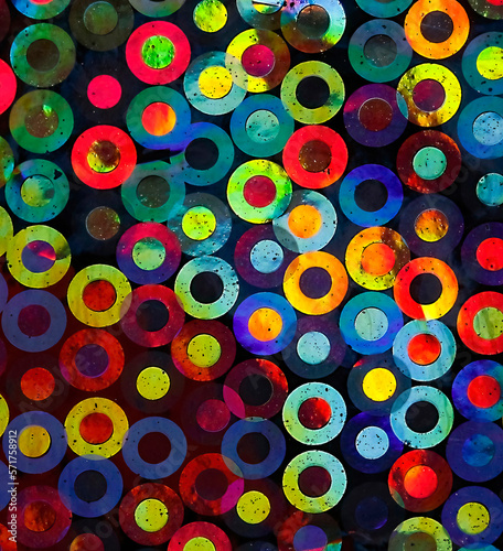 A colorful abstract background was created using a macro lens to capture the refraction of sunlight off the surface of the minuscule overlapping circles on the back of metallic tissue paper