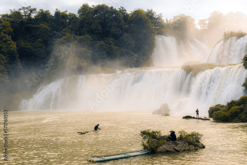 Fishermen at Detian Waterfalls in China, aka Ban Gioc in Vietnam is the fourth largest transnational waterfalls in the world. Located in Karst hills of Daxin County, Guangxi Province photo