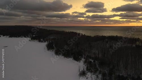 Snow covered shores. Pulling back with Aerial Drone and panning around the area. photo