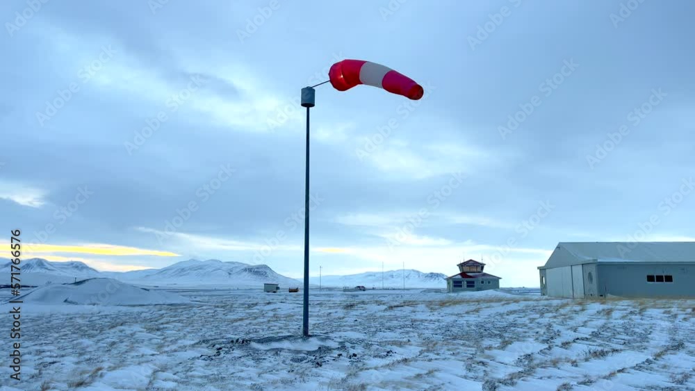 Wind sock slowly moving on Blönduos airfield in Iceland on a cold cloudy winter day Wind sock slowly moving on Blönduos airfield in Iceland on a cold cloudy winter day