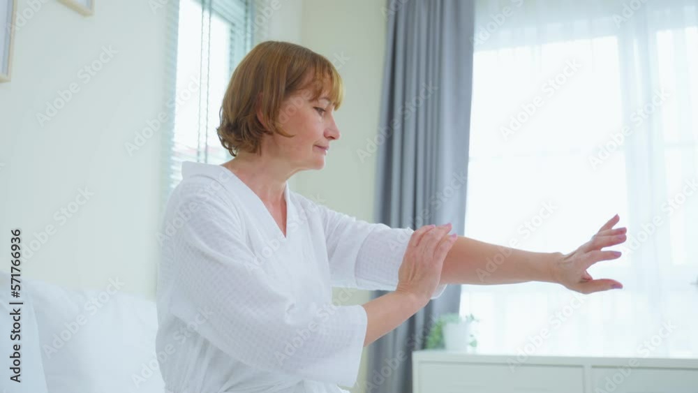 Caucasian senior woman put smooth and soft skin care on hand in bedroom. Caucasian senior woman put smooth and soft skin care on hand in bedroom.