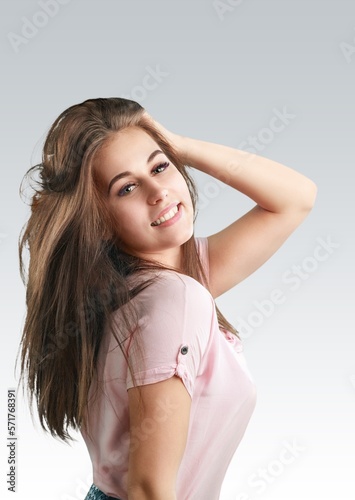 Happy young beautiful woman posing on background