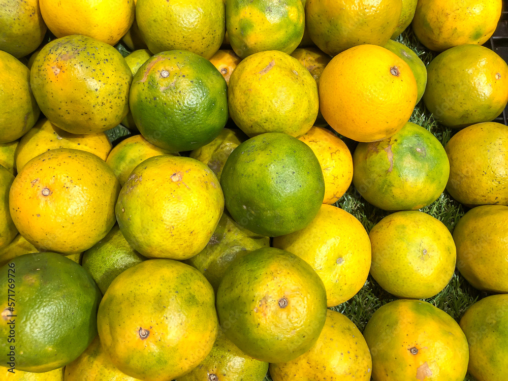 Orange fruit on the market, close up view of orange fruits.