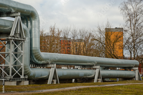 pipeline, in the background are residential buildings and a gray sky