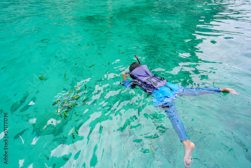 girl in snorkeling mask swims among the fish in Koh Phi Phi Island Thailand  Pileh Lagoon