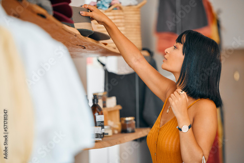 Fashion, store and woman customer shopping at a luxury retail clothing boutique in the city. Consumer, shop and young female buying clothes and accessories on sale, discount or promotion in town. photo