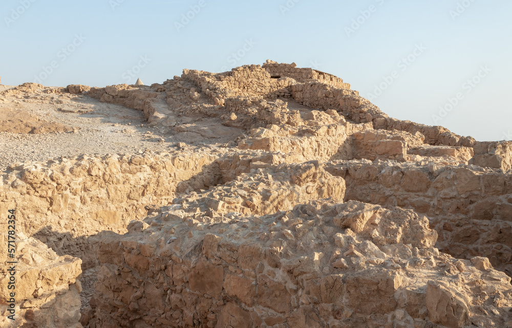 The remains  of internal buildings in the rays of the rising sun in the ruins of the fortress of Masada - is a fortress built by Herod the Great on a cliff-top off the coast of the Dead Sea,  Israel