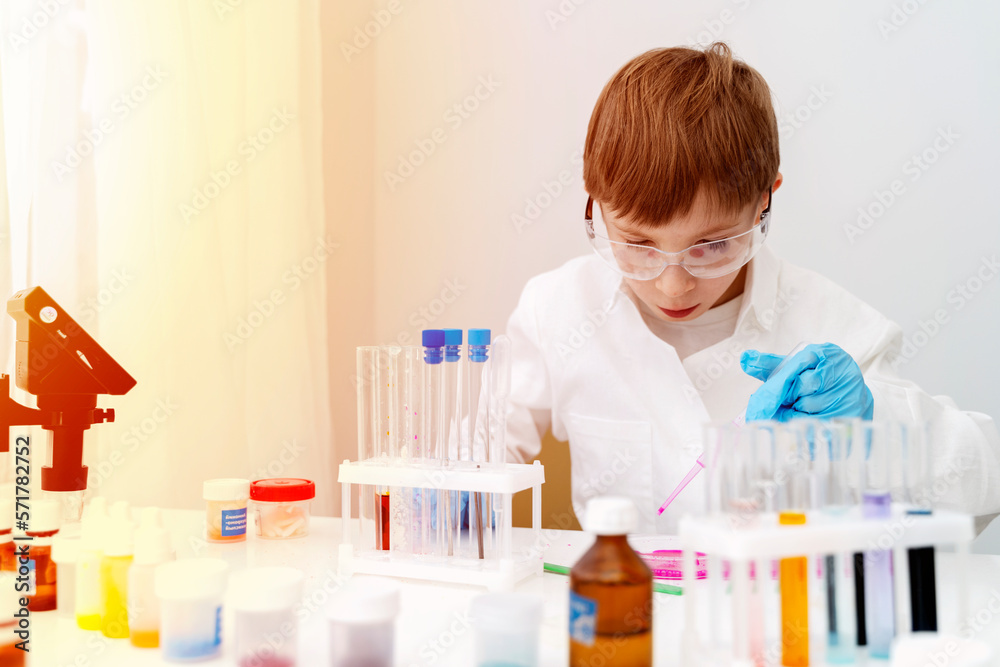 the boy conducts experiments in a chemical laboratory the boy conducts experiments in a chemical laboratory