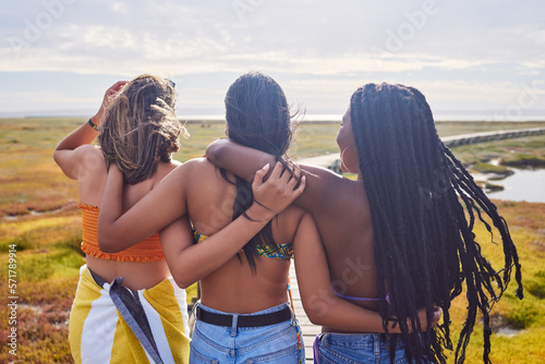Back, friends and women on countryside vacation and bonding on weekend break, sisterhood and relax together. Females, girls and hug on holiday, journey and adventure for peace, loving or quality time photo