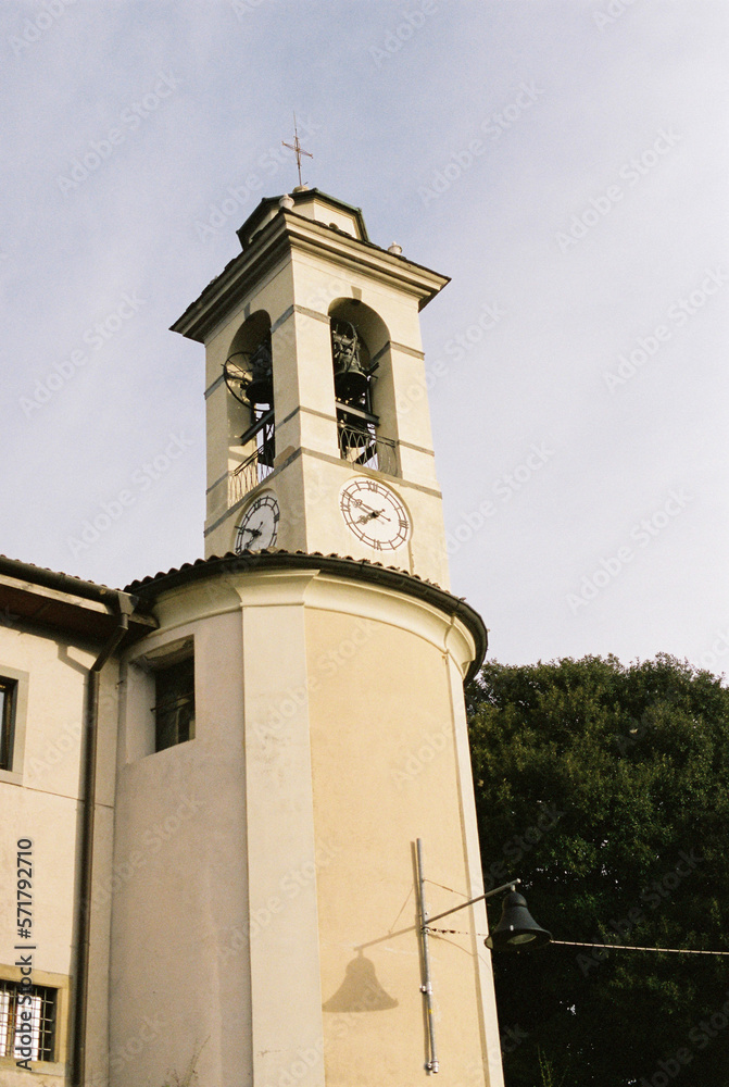 High bell tower with a clock on the facade. Bergamo, Italy