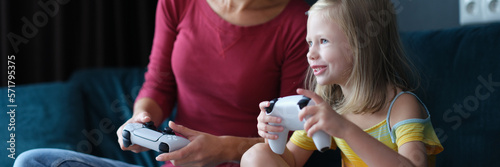 Mother and child girl playing video games