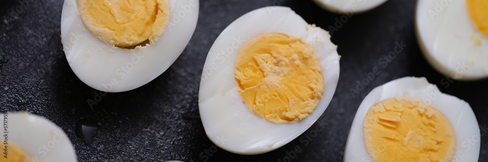 Sliced hard boiled eggs on dark background Sliced hard boiled eggs on dark background