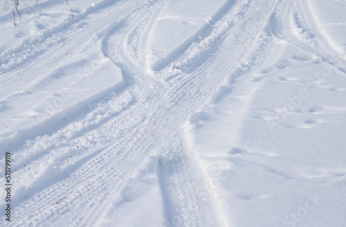 Track from the car on white snow into the distance. © Prikhodko
