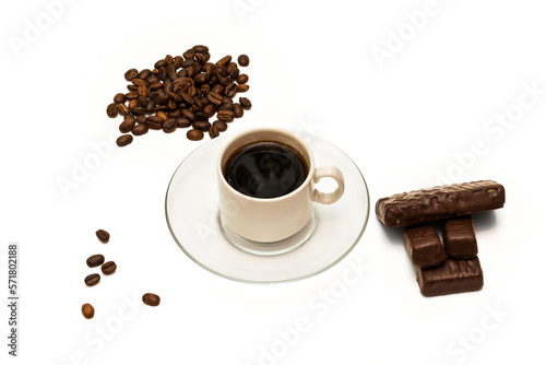 Grains of coffee, a cup of coffee and chocolate sweets