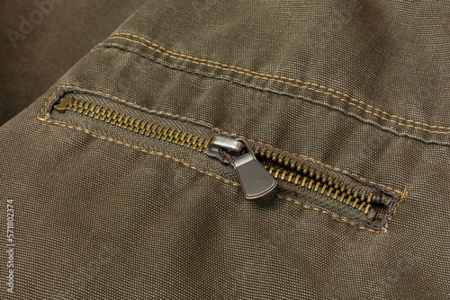 Element of clothing. Zipper closes pocket on clothes