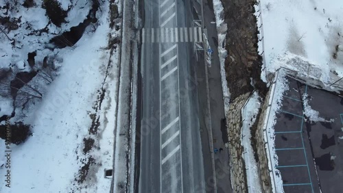 Zenithal shot of fire brigade van driving on snowy road photo