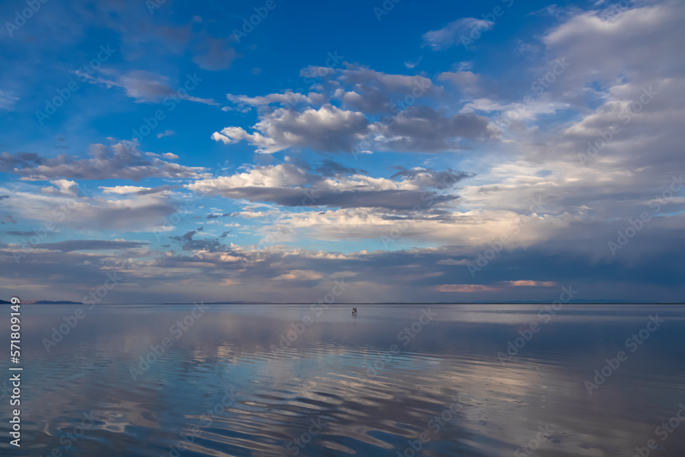 Scenic view of beautiful water reflections in lake of Bonneville Salt Flats at sunset, Wendover, Western Utah, USA, America. Dreamy clouds mirroring on the water surface creating romantic atmosphere