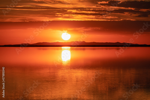 Fototapeta Naklejka Na Ścianę i Meble -  Scenic sunrise view of beautiful water reflections in lake of Bonneville Salt Flats, Wendover, Western Utah, USA, America. Dreamy clouds mirroring on the water surface creating romantic atmosphere