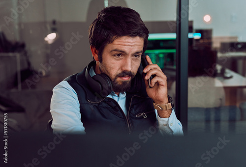 Programmer, phone call and man talking, thinking or chatting and speaking to contact at night office. Information technology, idea and male coder with mobile for networking while looking at computer.