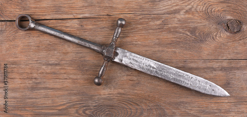 Knight sword on wooden background