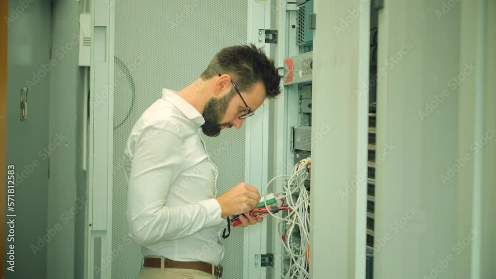 specialist configuring server rack in server room specialist configuring server rack in server room