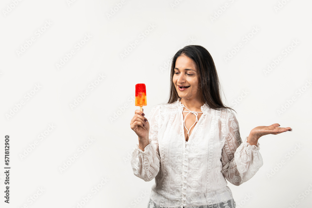 happy asian woman holding ice pop, a lolly frozen stick with mango yellow, fruit ice cream happy asian woman holding ice pop, a lolly frozen stick with mango yellow, fruit ice cream