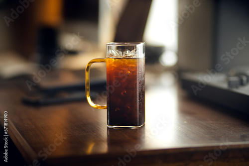 Iced americano coffee in glass on work table at home