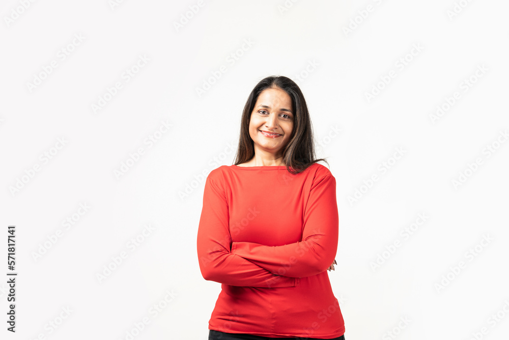 Happy successful Indian woman standing in casual outfit, confident, smiling pleased at camera Happy successful Indian woman standing in casual outfit, confident, smiling pleased at camera