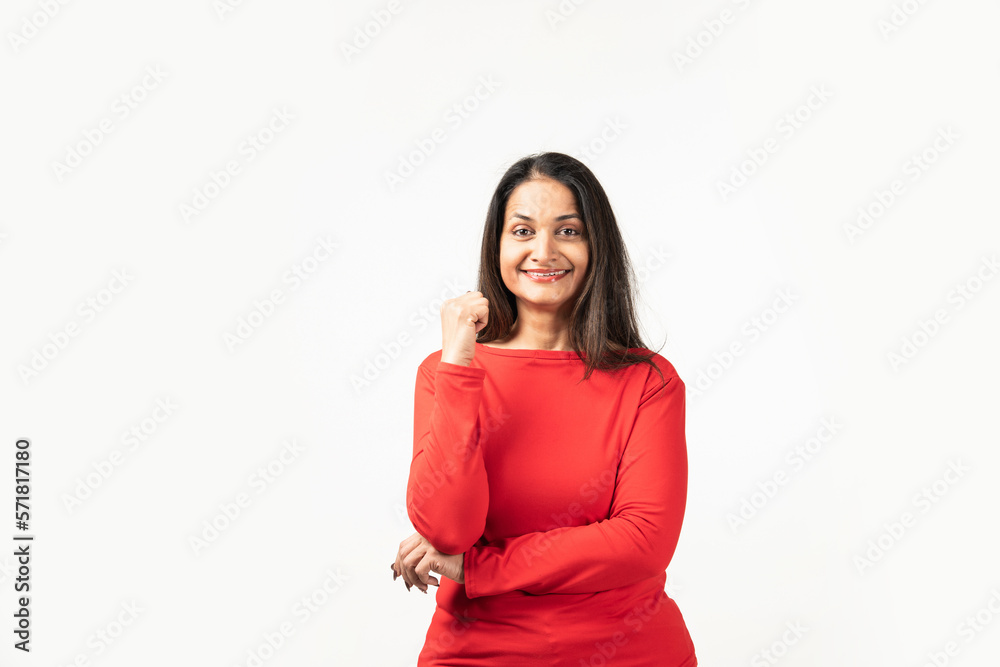 Happy successful Indian woman standing in casual outfit, confident, smiling pleased at camera Happy successful Indian woman standing in casual outfit, confident, smiling pleased at camera