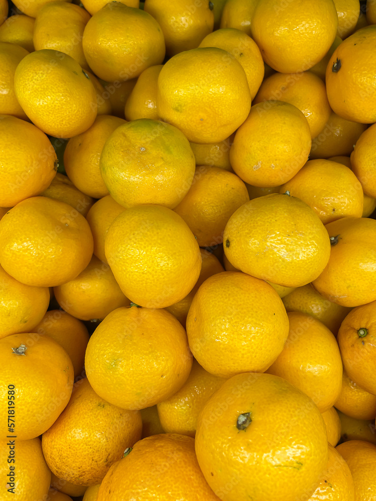lots of yellow ripe tangerine vitamins taste fruit for food as background lots of yellow ripe tangerine vitamins taste fruit for food as background