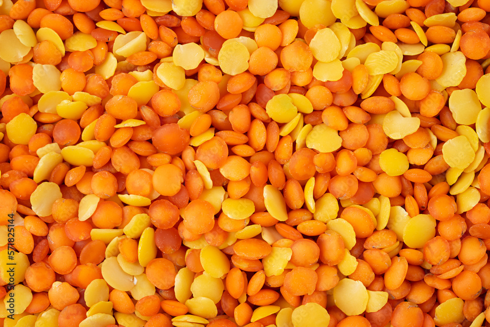 Mix of red and yellow lentils background or texture. Closeup, top view Mix of red and yellow lentils background or texture. Closeup, top view