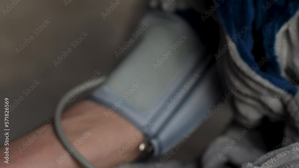 close-up Caucasian pensioner aged 70-79 measures his blood pressure. selective focus.health care in old age concept. measurement of blood pressure by a pensioner. Be healthy theme close-up Caucasian pensioner aged 70-79 measures his blood pressure. selective focus.health care in old age concept. measurement of blood pressure by a pensioner. Be healthy theme
